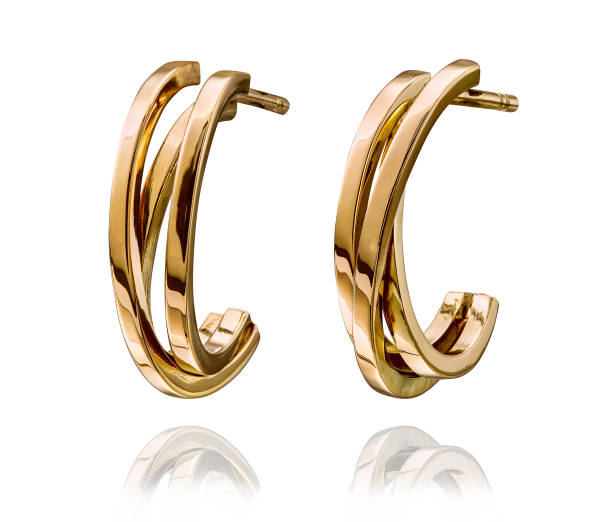 Inicio golden earrings with gemstone isolated on white background.